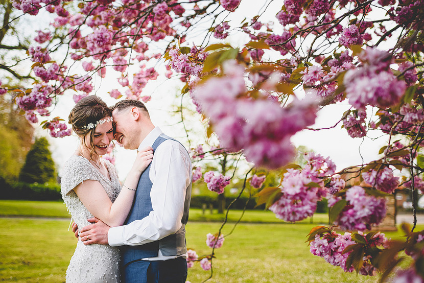 english country wedding photgraphy kissing in blossum