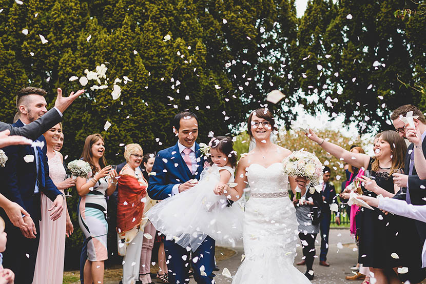 sprowston manor norfolk wedding photography ray becky and pihilipa walking through confetti