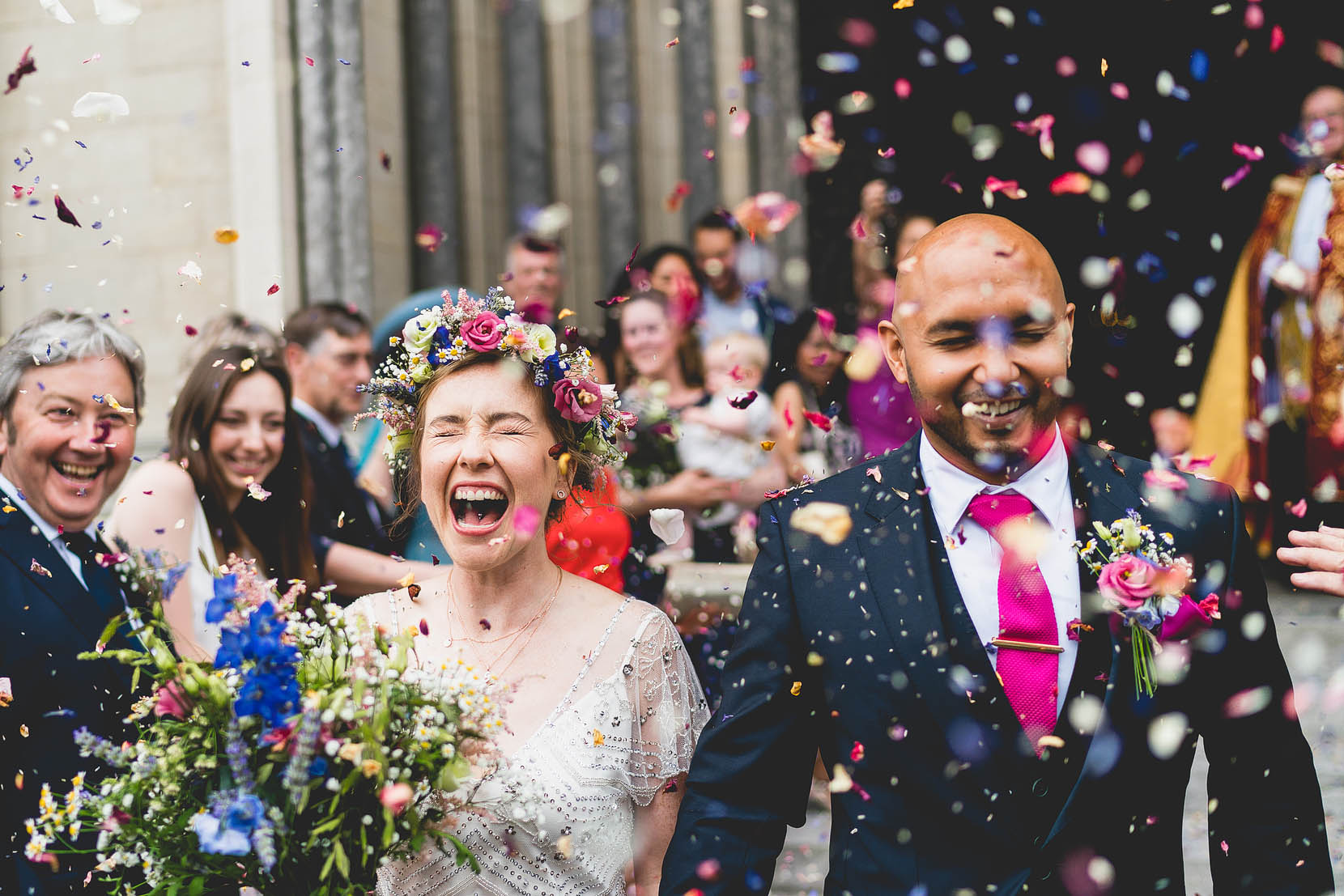 navin and sarah step outside st john the baptist cathedral in norwich after getting married