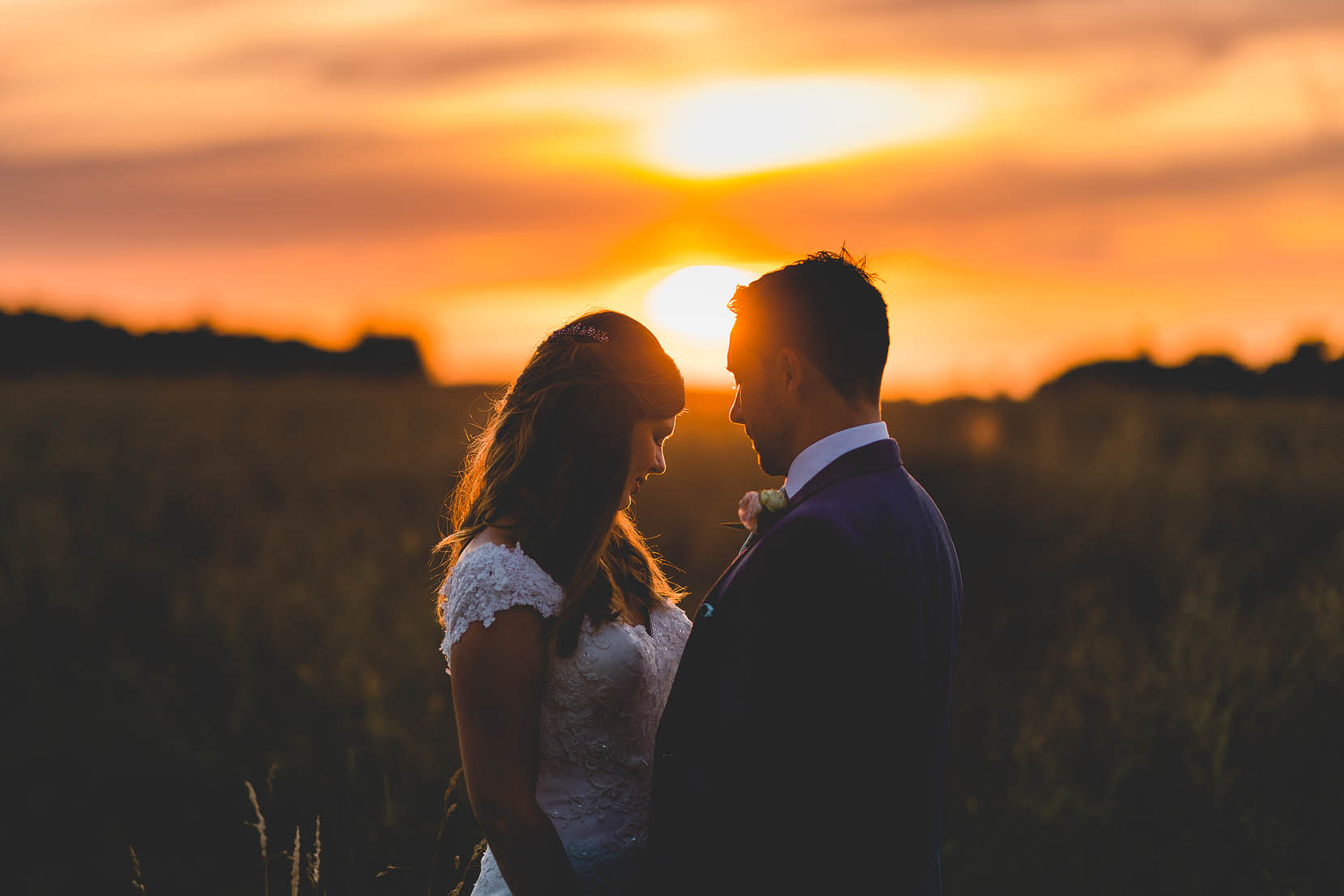 Michael & Philippa just married snuggle at sunset in ranwroth, norfolk