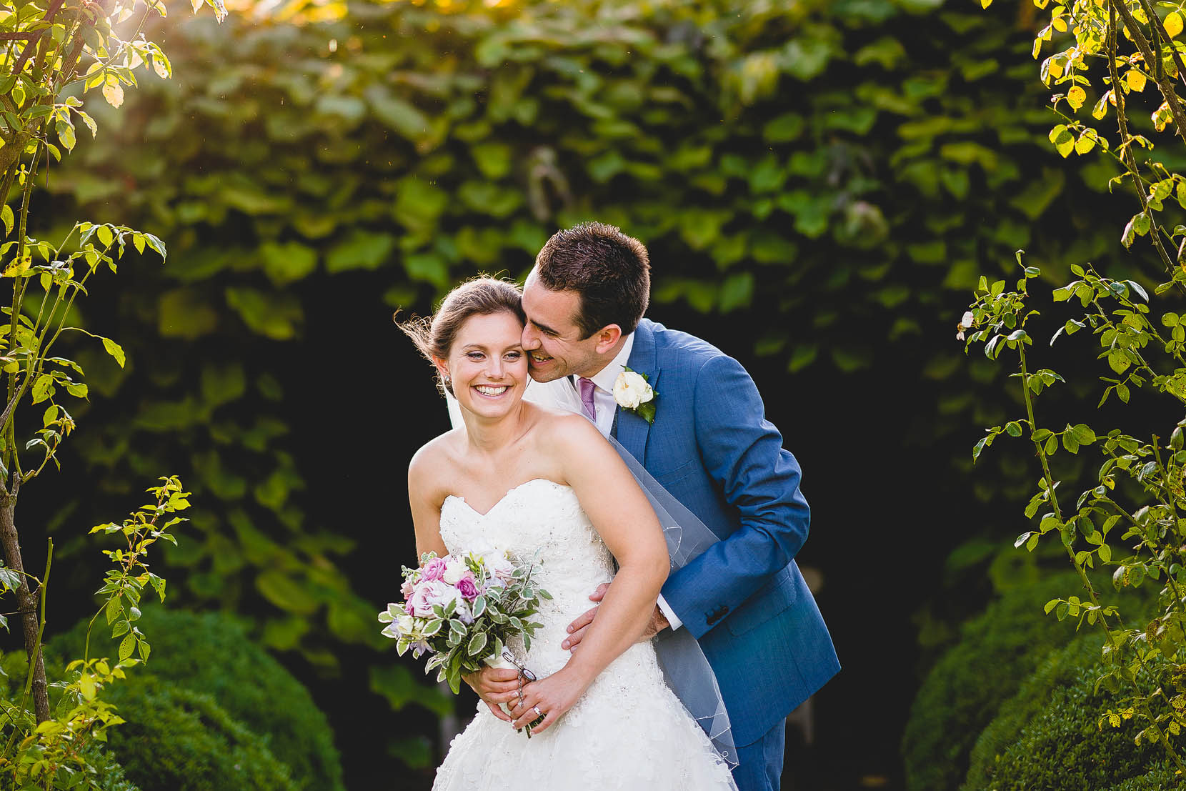 Elms barn bride and groom having a cuddle in some lovely evening light