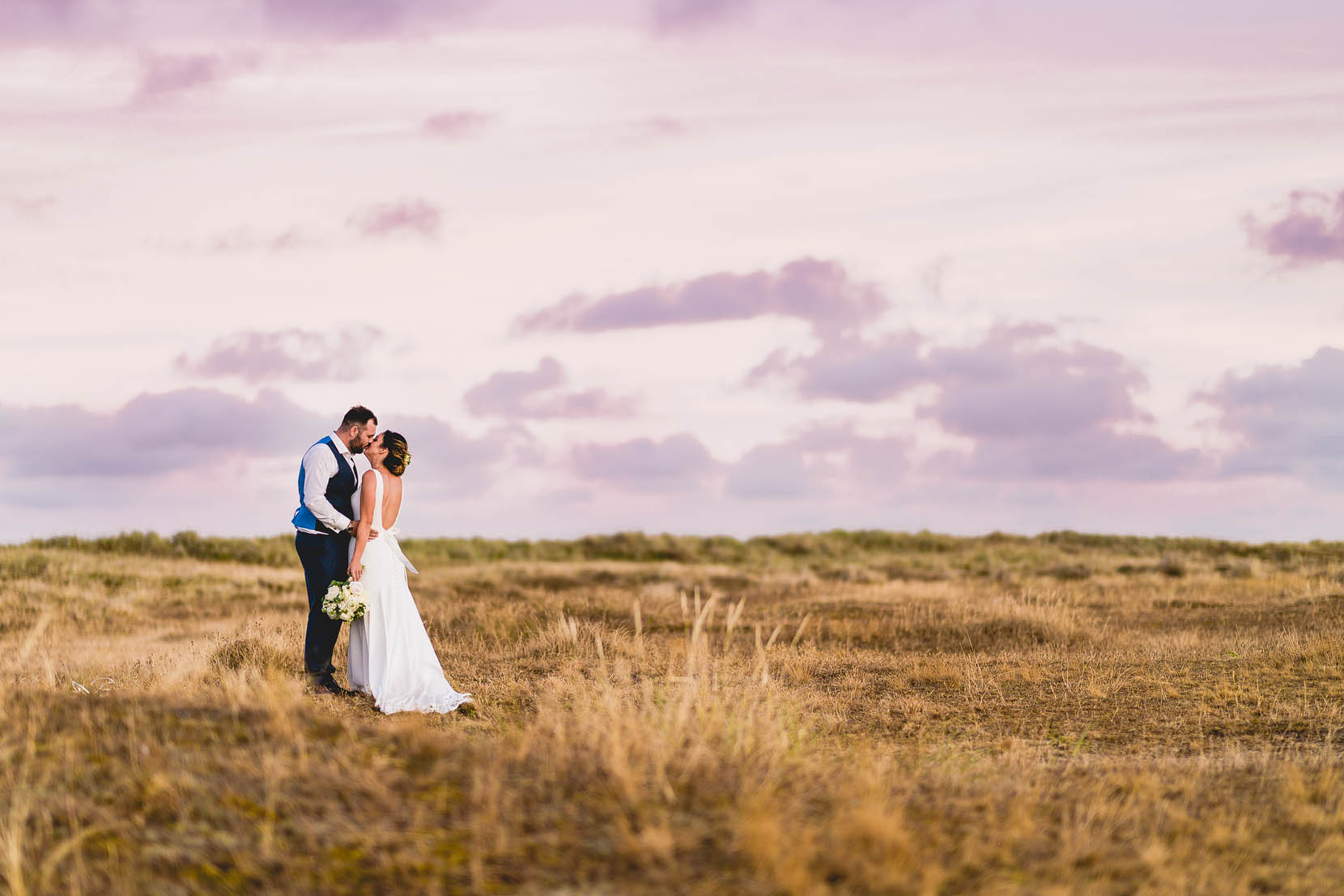 Great Yarmouth Wedding Photography, Katie & Rob on the beach having a snog in some golden evening light