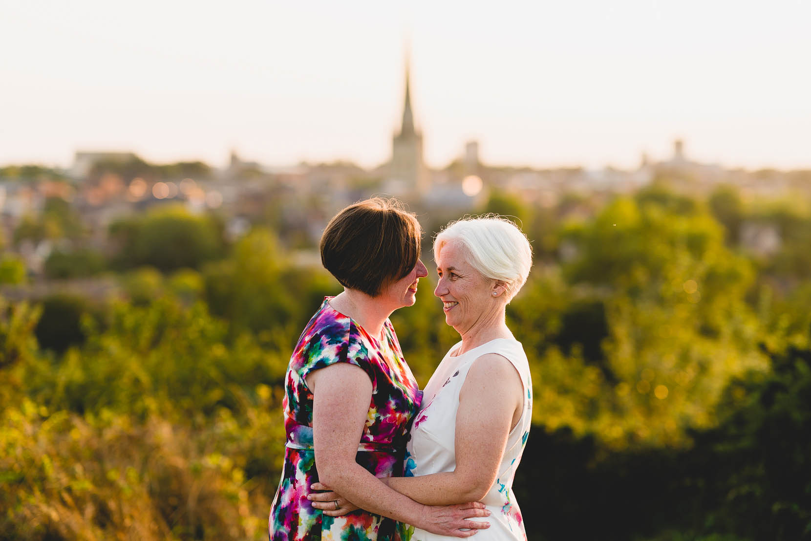 Amanda and Louise share a cuddle on top of Norwich, Norfolk after their same sex wedding