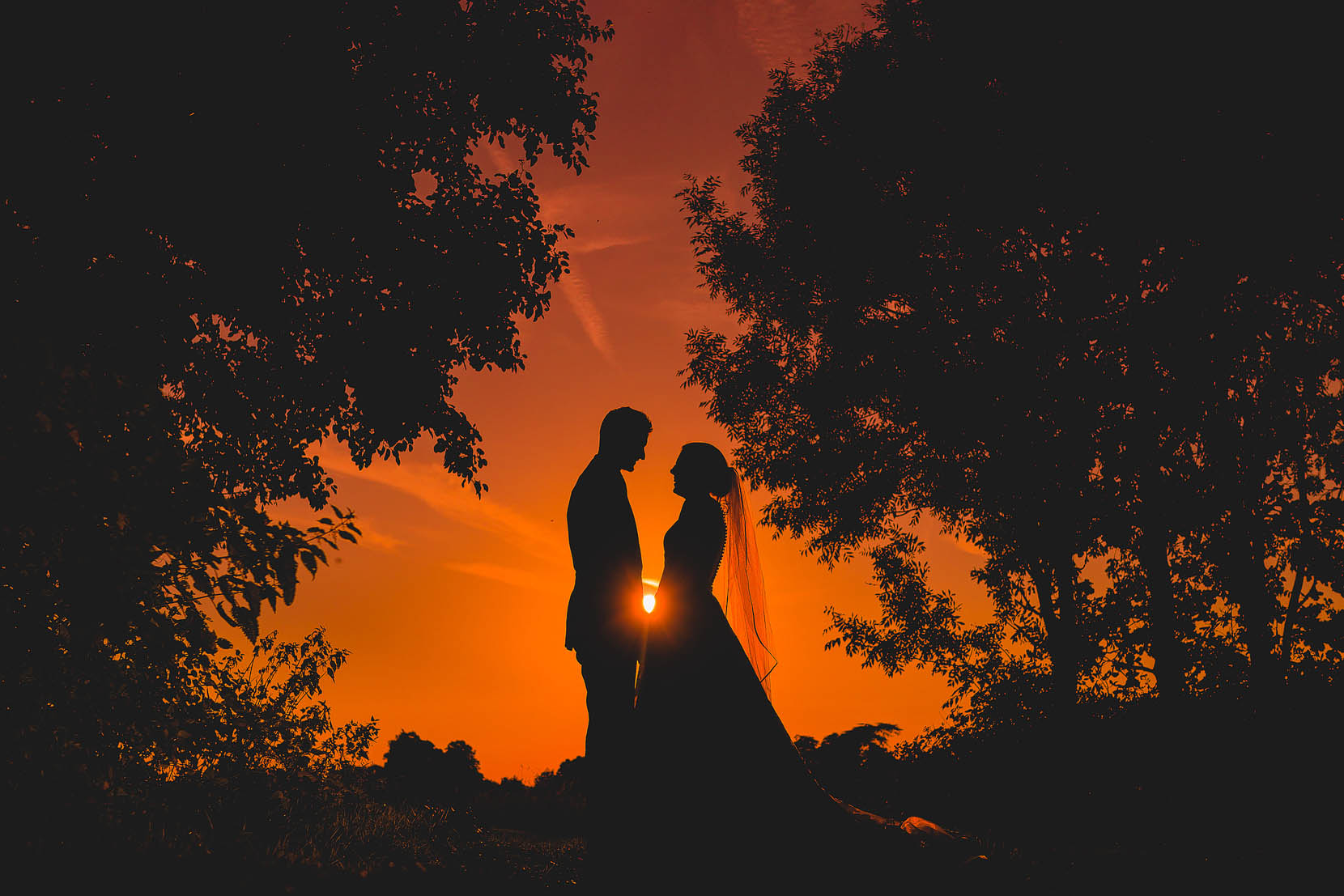 Spixworth Hall cottages wedding in Norfolk with Rachel and Richard sharing a cuddle during sunset