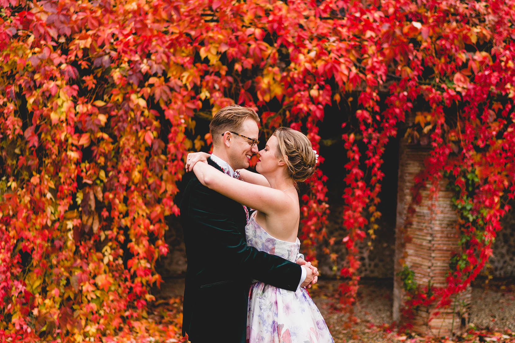 Wedding Photography at Norfolks Voewood infront of a fire red autumnal leafy backdrop